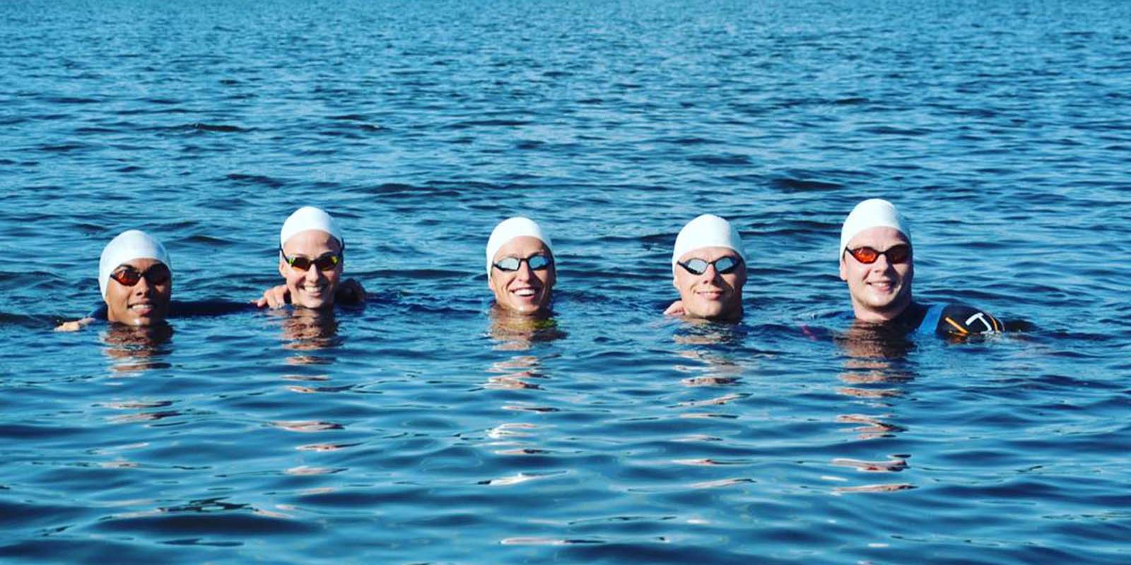 Group of swimmers in the ocean smiling