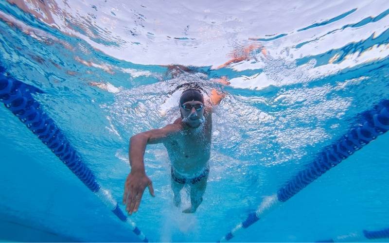 Guy swimming freestyle from underwater