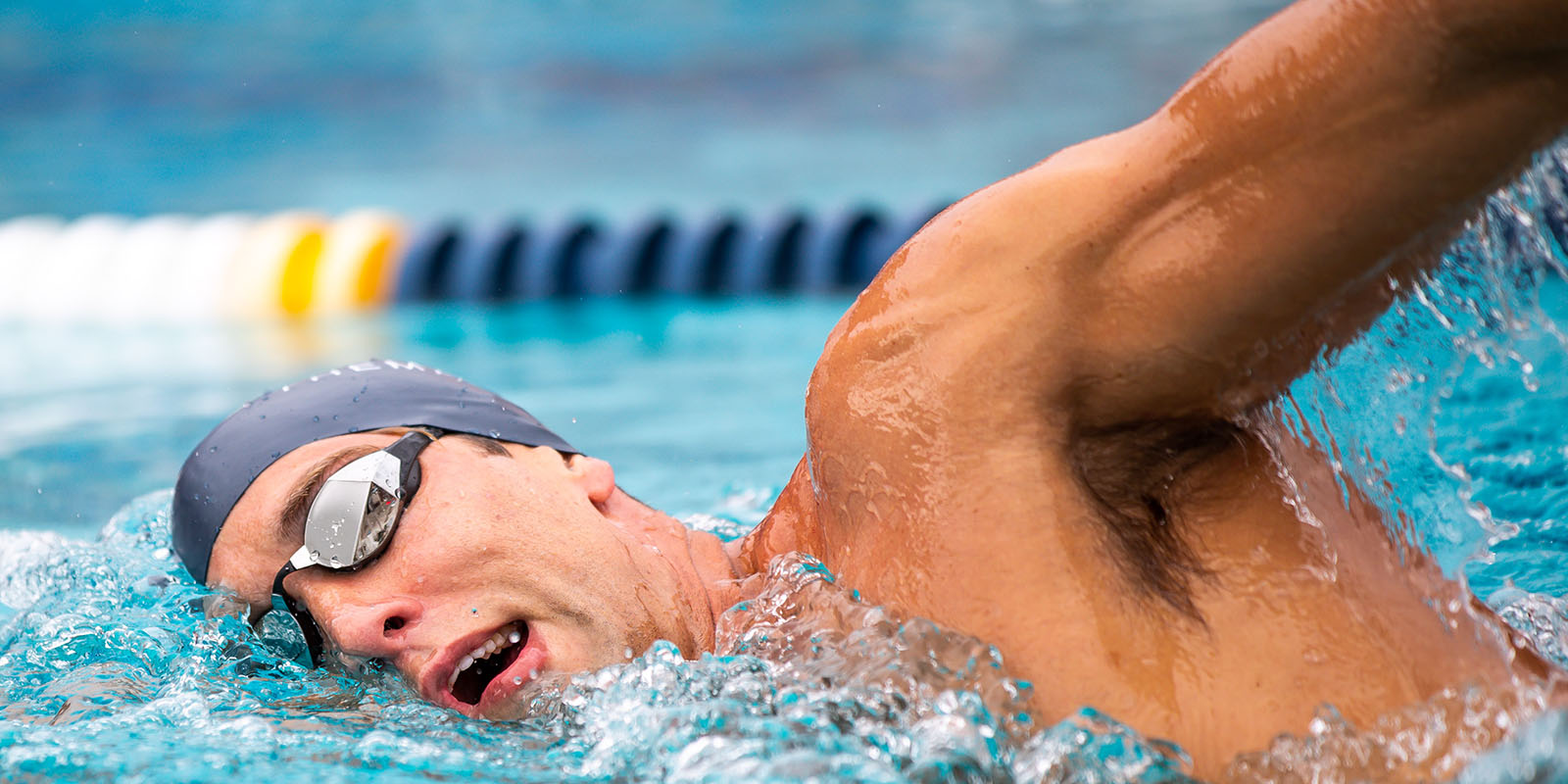 A swimmer comes up for a breath between strokes