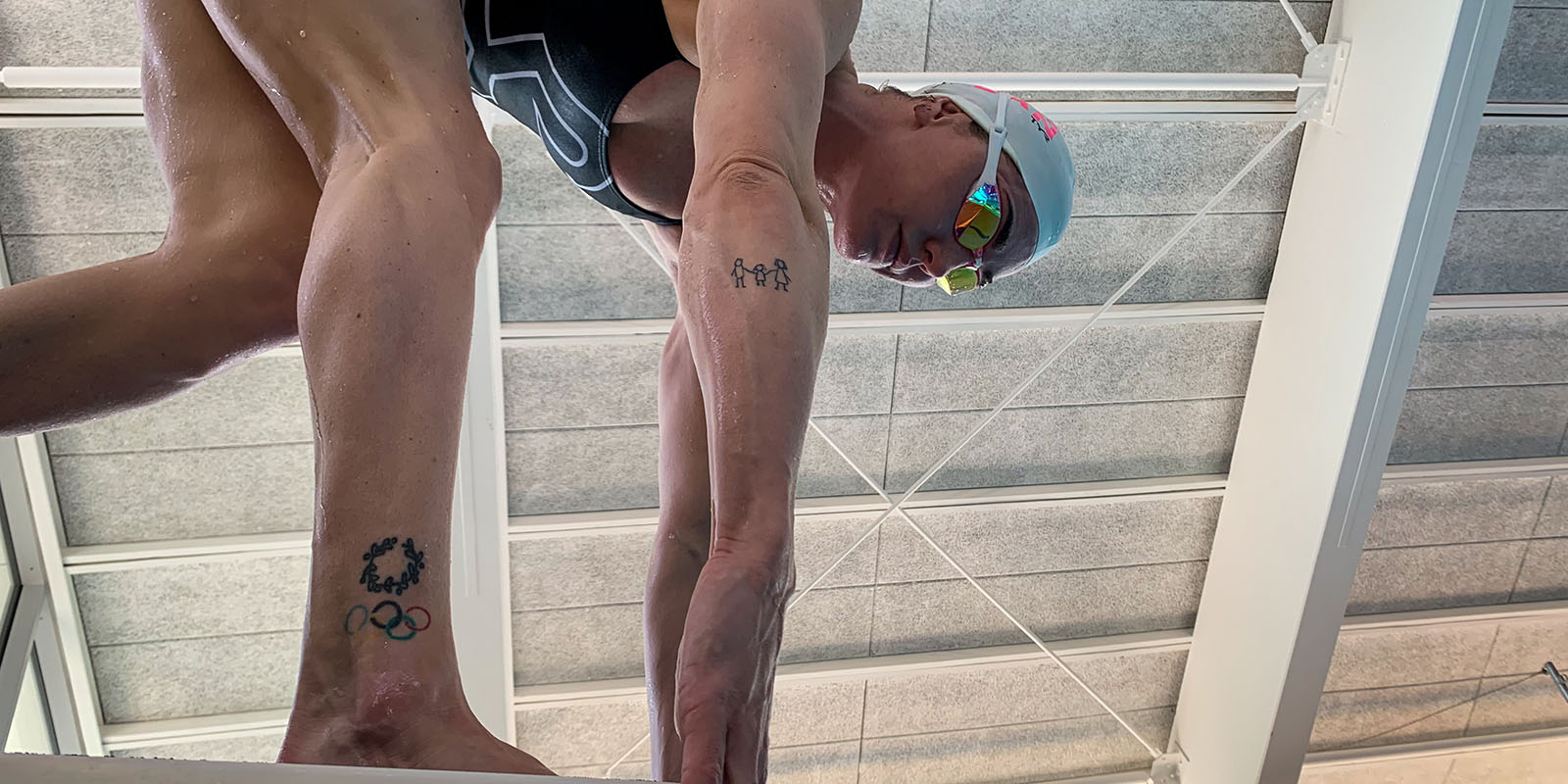 Swimmer behind the starting blocks