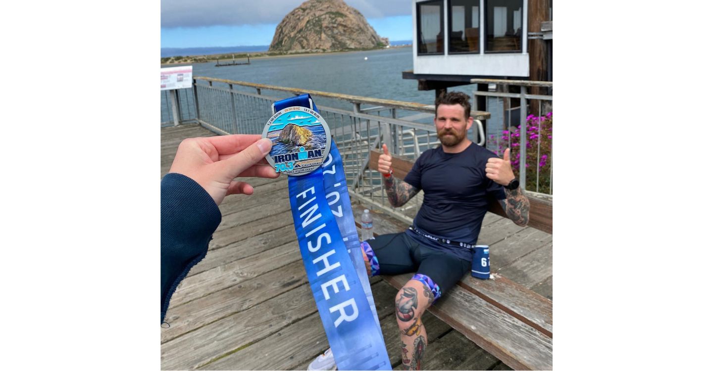 MacKay showing off his Ironman award