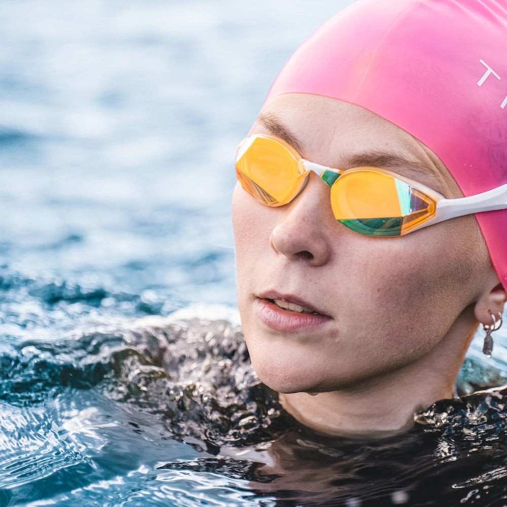 Open water swimmer wearing Blue Gold Mirror Swedish Edition swim goggles