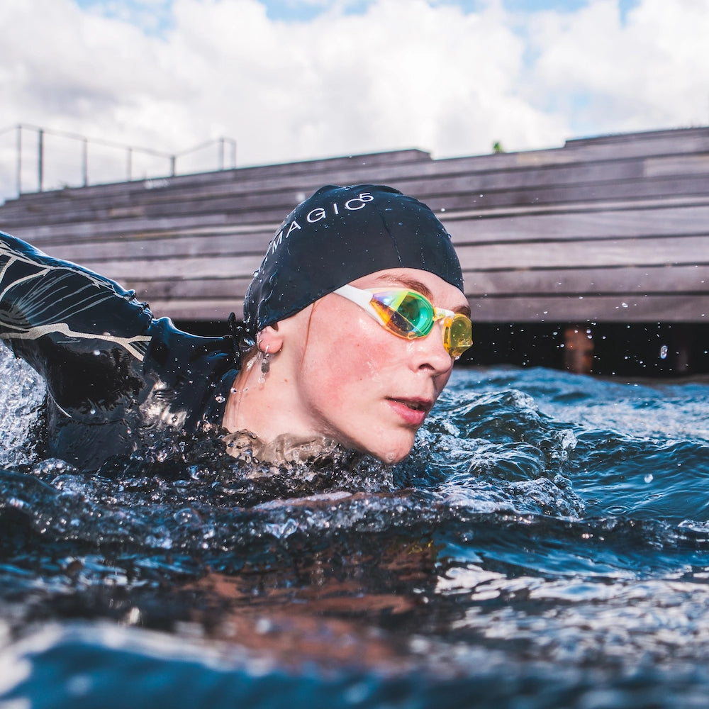 Open water swimmer wearing Blue Gold Mirror Swedish Edition swim goggles during training