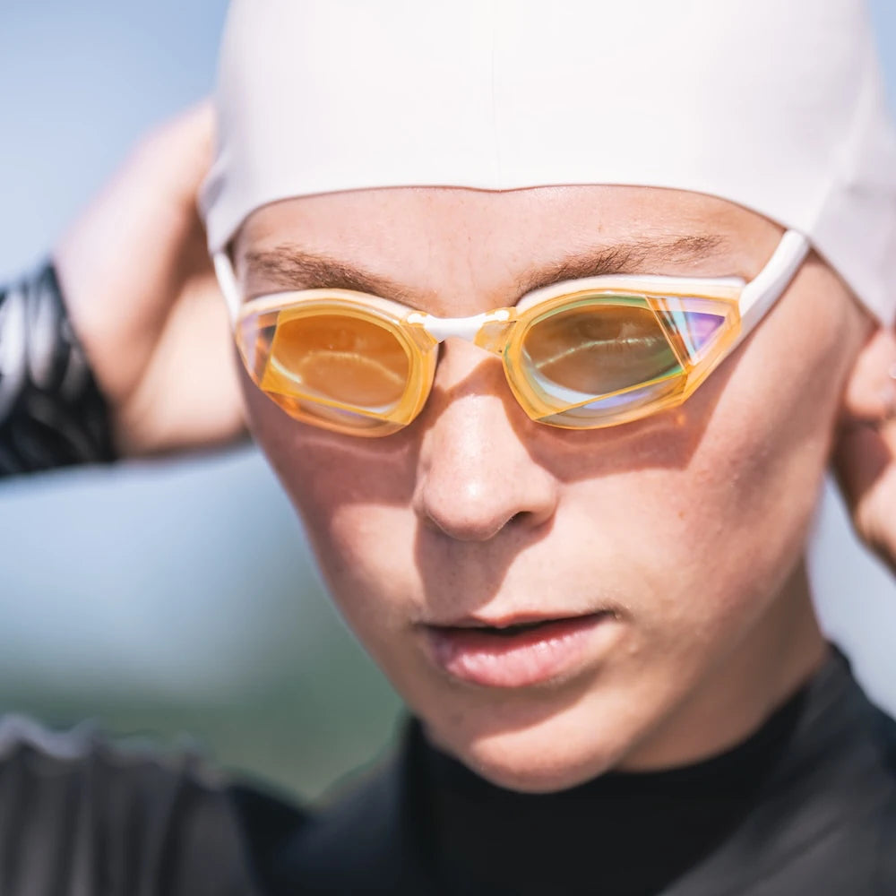 Swimmer wearing Blue Gold Mirror Swedish Edition swim goggles before open water training