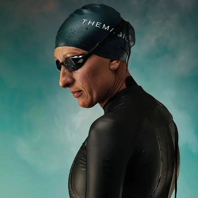 Triathlete wearing Black Magic Mirror Silver swim goggles before open water training
