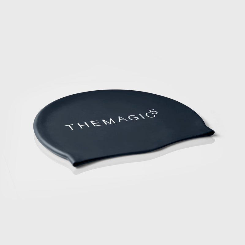 Navy blue silicone swim cap by THEMAGIC5 for swimming, training, and competitive pool sessions.